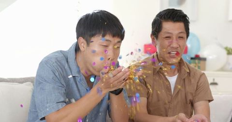 Father and Son Bonding Celebration with Colorful Confetti