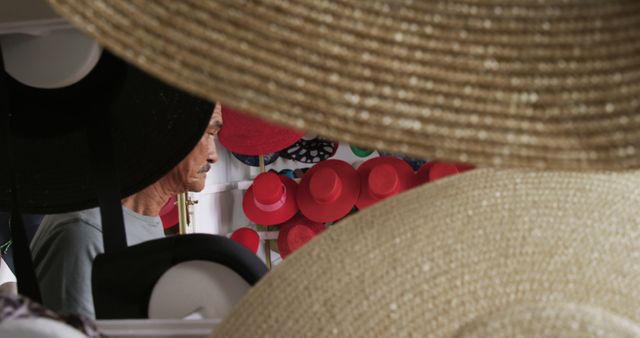 Senior Man Surrounded by Colorful Hats in Market - Download Free Stock Images Pikwizard.com