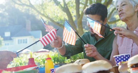 Celebrating Independence Day with Flags and Burgers Outdoors