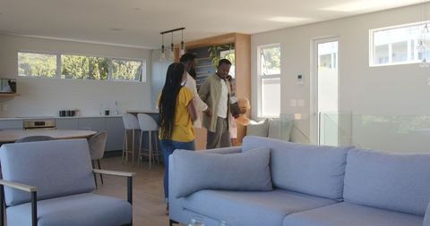 Family Entering Stylish Modern Living Room