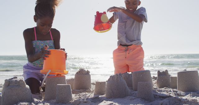 Children Building Sandcastles on Sunny Beach - Download Free Stock Images Pikwizard.com