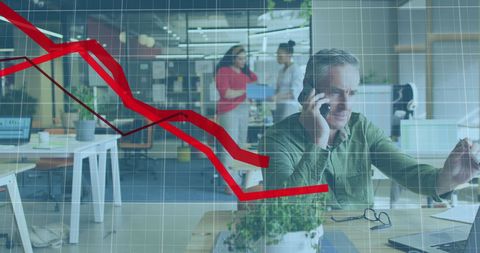 Businessman on smartphone with stock market decline graph overlay