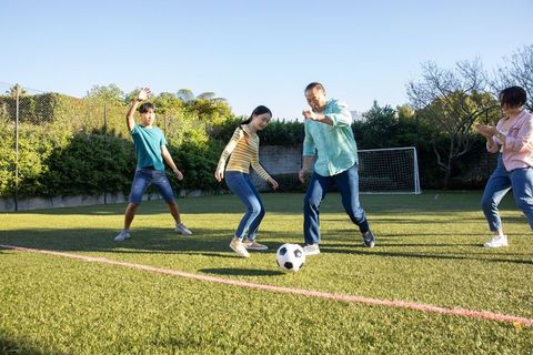 Family Bonding Through Soccer on Backyard Grass Field