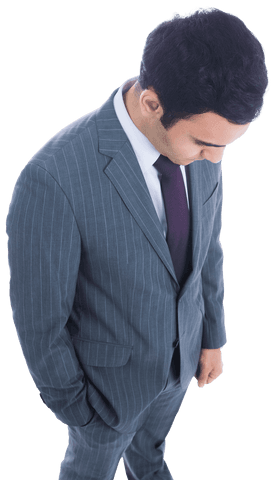 Serious biracial businessman in a suit seen looking down with a transparent background. Useful for business and corporate presentations, creating professional materials, thinking concepts, and leadership themes.