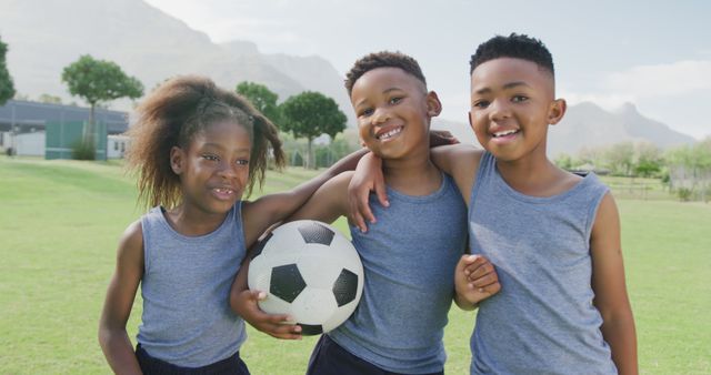 Three Happy Kids Playing Soccer on Grassy Field - Download Free Stock Images Pikwizard.com