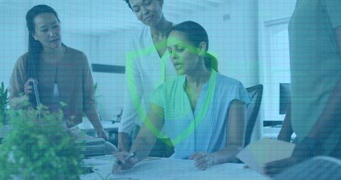 Diverse Team Discussing Cybersecurity Strategies in Modern Office