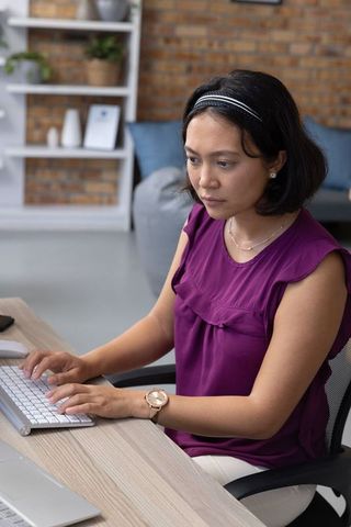 Professional Woman Typing at Modern Home Office Desk