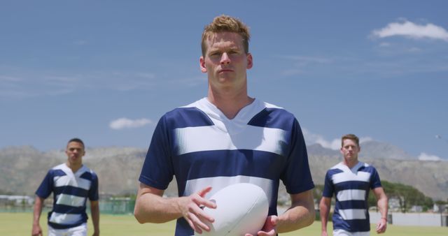 Three Rugby Players Holding Ball Outdoors on Sunny Day - Download Free Stock Images Pikwizard.com