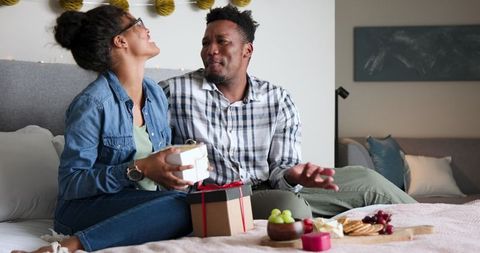 Romantic Couple Celebrating Anniversary with Gift Exchange at Home
