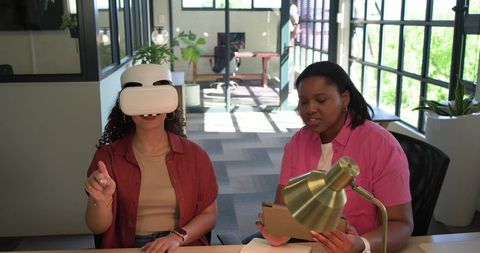 African american colleagues testing vr headset during coworkorking demo in bright office