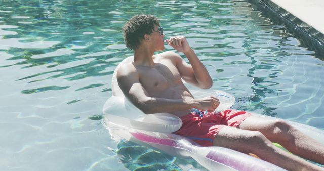 Relaxing Young Man Floating on Inflatable Pool Lounge with Snack - Download Free Stock Images Pikwizard.com