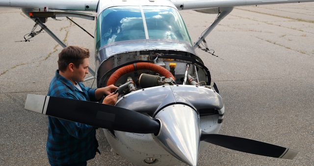 Male Engineer Checking Small Aircraft Engine Outdoors - Download Free Stock Images Pikwizard.com