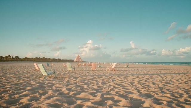 Pastel Lounge Chairs on Serene Sandy Beach
