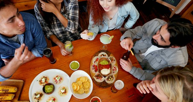 Friends Enjoying Casual Dining Together in a Restaurant - Download Free Stock Images Pikwizard.com