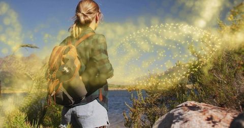Adventurous Woman Hiking by Lakeside with Magic Sparkles