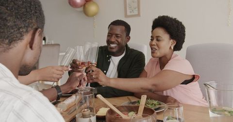 Friends Celebrating with Joyful Meal and Cheers