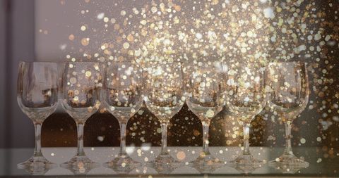Glittering Gold Lights Above Array of Wine Glasses - Download Free Stock Images Pikwizard.com