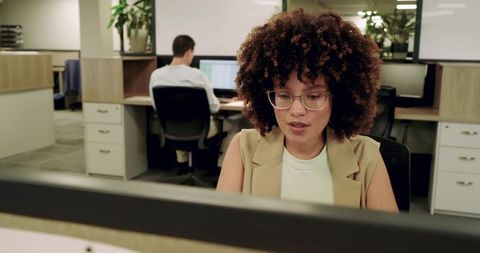 Focused team working in modern open plan office
