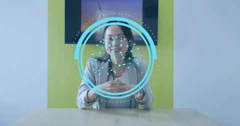 Businesswoman interacting with facial recognition technology