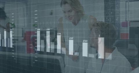 Business team analyzing digital bar chart overlay collaborating in modern open-plan office
