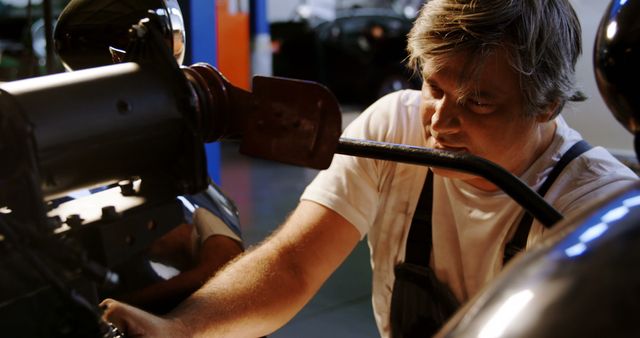 Dedicated Mechanic Working on a Car Engine in Garage - Download Free Stock Images Pikwizard.com