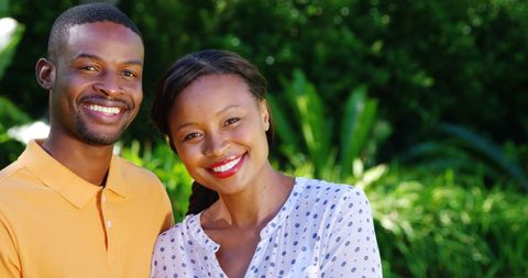 Joyful couple posing outdoors with nature background