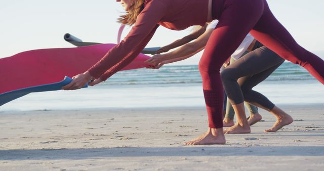 Women on Beach Spreading Yoga Mats for Morning Session - Download Free Stock Images Pikwizard.com