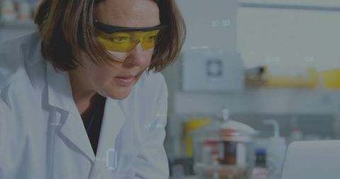 Female Scientist Analyzing Data with Laptop in Laboratory