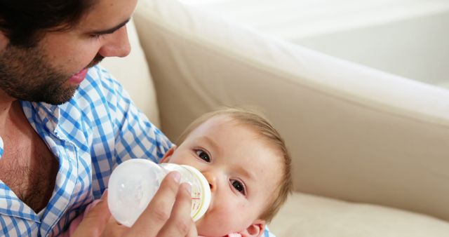 Loving Father Feeding Baby Bottle Milk at Home - Download Free Stock Images Pikwizard.com