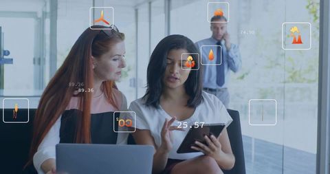 Collaborating on augmented reality data dashboard using tablet and laptop in modern office