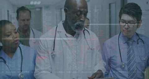 Diverse Medical Team Analyzing Patient Data in Hospital Hallway