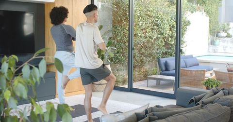 Two Friends Doing Yoga at Home with Patio View