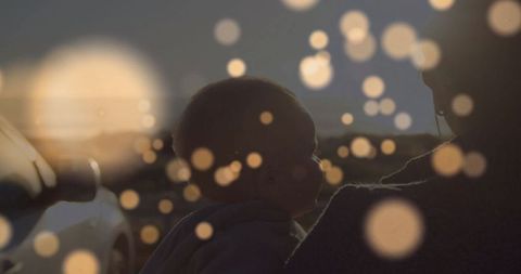 Evening roadside moment: mother holding infant