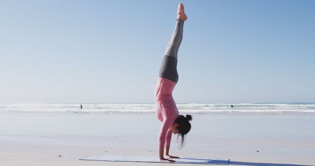 Woman Practicing Handstand Yoga on Tranquil Beach - Download Free Stock Images Pikwizard.com