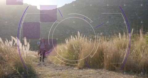 Hiker Walking Through Valley Tall Grass with High-Tech Overlay