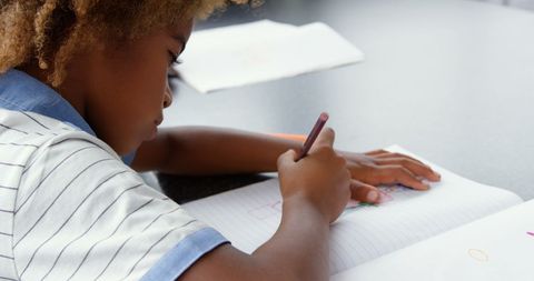 Child Focused on Drawing in Classroom with Colored Pencil - Download Free Stock Images Pikwizard.com