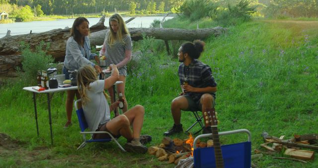 Friends Camping by Cozy Riverside Campfire - Download Free Stock Images Pikwizard.com