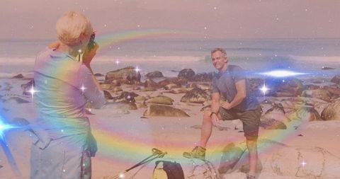 Playful couple hiking on scenic beach with magic effects