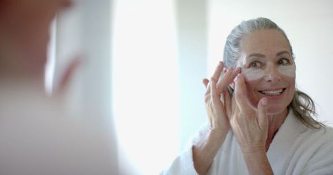 mature woman using under-eye patches in morning skincare routine - Download Free Stock Images Pikwizard.com