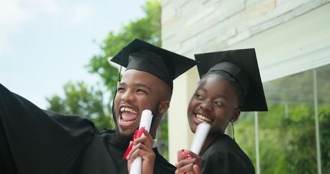 Joyful African American Graduates Celebrating Success Outdoors
