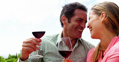 Romantic Couple Enjoying Wine and Laughter Outdoors - Download Free Stock Images Pikwizard.com