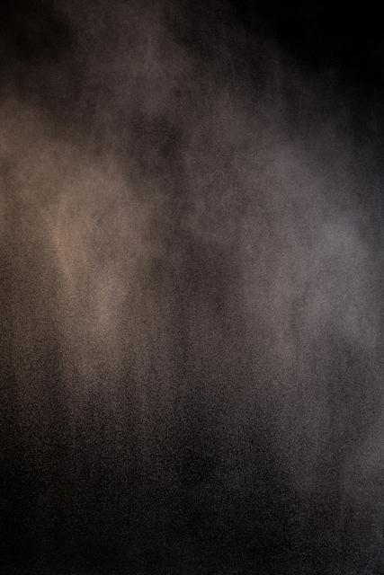 Abstract dust powder splash on black background creates a mysterious and atmospheric effect. Ideal for use in artistic projects, backgrounds for presentations, or as a texture overlay in graphic design. The fine particles and misty appearance add a sense of depth and intrigue, making it suitable for themes related to mystery, science, or fantasy.
