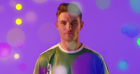 Confident Soccer Player Sporting Team Jersey Against Vibrant Backdrop