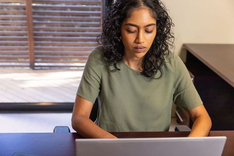 Focused Female Professional Working in Modern Home Office