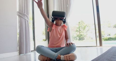 Excited Young Girl Exploring Virtual Reality at Home