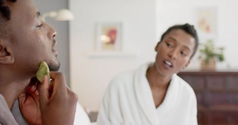 African american couple grooming with natural sponge during calm morning skincare routine