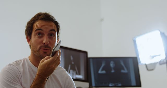 Young Man Using Smartphone with Voice Command in Office - Download Free Stock Images Pikwizard.com