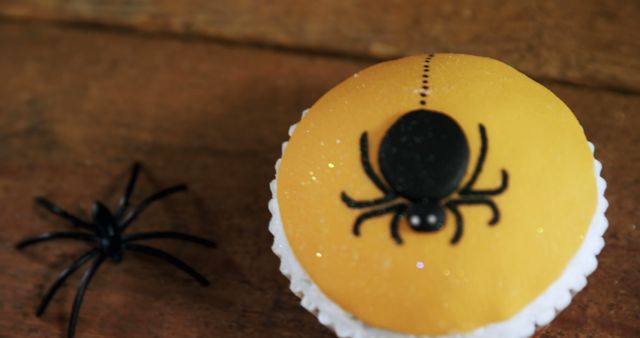 Spider-Themed Cupcake and Toy Spider on Wooden Surface - Download Free Stock Images Pikwizard.com