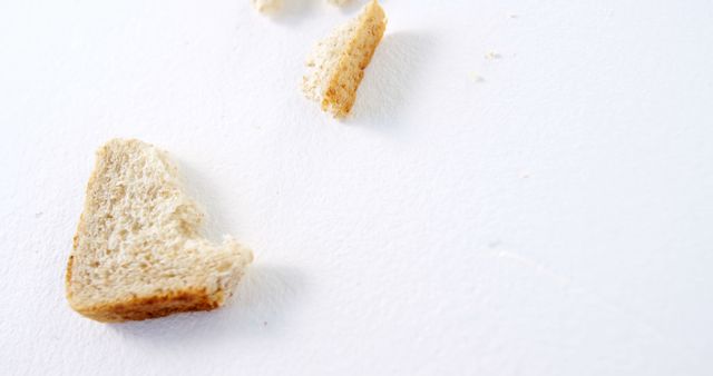 Pieces of bread crumbs on white table - Download Free Stock Images Pikwizard.com