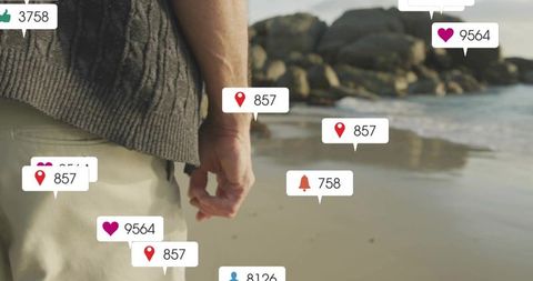 Man walking on beach with digital social icons overlay